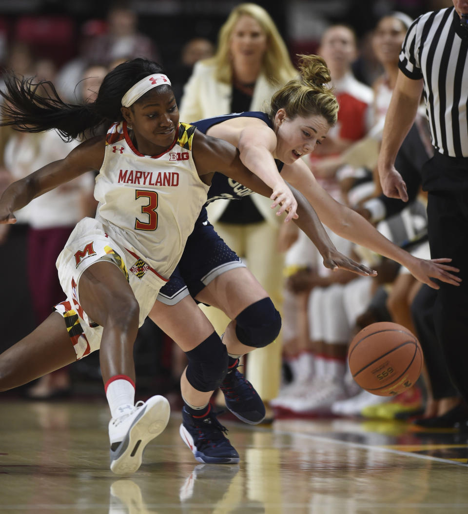 Maryland's Kaila Charles, left and Connecticut's Katie Lou Samuelson chase the ball during the first half of an NCAA college basketball game, Thursday, Dec. 29, 2016 in College Park, Md. (AP Photo/Gail Burton)