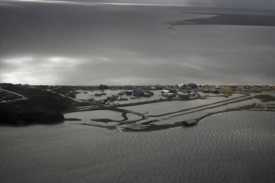 In this image provided by the U.S. Coast Guard, a Coast Guard Air Station Kodiak aircrew flies over Golovin, Alaska, to assess damage to houses and facilities, Sept. 18, 2022. Authorities are making contact with some of the most remote villages in the United States to determine the need for food and water and assess damage from a massive weekend storm that flooded communities dotting Alaska's vast western coast. (Petty Officer 3rd Class Ian Gray/U.S. Coast Guard via AP)