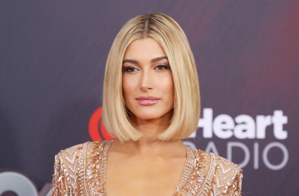 <p>Hailey Baldwin cut is angled perfectly to create a symmetrical look. To recreate, run a flat iron through <a rel="nofollow noopener" href="https://www.womansday.com/style/beauty/advice/g2276/homemade-hair-treatments/" target="_blank" data-ylk="slk:your hair;elm:context_link;itc:0;sec:content-canvas" class="link ">your hair</a> and turn it in toward your hair at the ends. Finish with hair shine mist to <a rel="nofollow noopener" href="https://www.womansday.com/style/beauty/g904/frizzy-hair-remedies/" target="_blank" data-ylk="slk:avoid frizz;elm:context_link;itc:0;sec:content-canvas" class="link ">avoid frizz</a>. </p><p><strong>What you'll need</strong>: Flat iron ($60, <a rel="nofollow noopener" href="https://www.amazon.com/CHI-Original-Straightening-Ceramic-Hairstyling/dp/B0009V1YR8/?tag=womansday_auto-append-20&ascsubtag=%5Bartid%7C10070.g.796%5Bsrc%7C%5Bch%7C" target="_blank" data-ylk="slk:amazon.com;elm:context_link;itc:0;sec:content-canvas" class="link ">amazon.com</a>); hair shine mist ($20, <a rel="nofollow noopener" href="https://www.amazon.com/TIGI-Head-Shine-Unisex-Ounce/dp/B000VZDWB8?tag=womansday_auto-append-20&ascsubtag=%5Bartid%7C10070.g.796%5Bsrc%7C%5Bch%7C" target="_blank" data-ylk="slk:amazon.com;elm:context_link;itc:0;sec:content-canvas" class="link ">amazon.com</a>)</p>