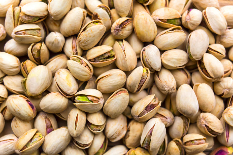 Group of fresh salted pistachios background