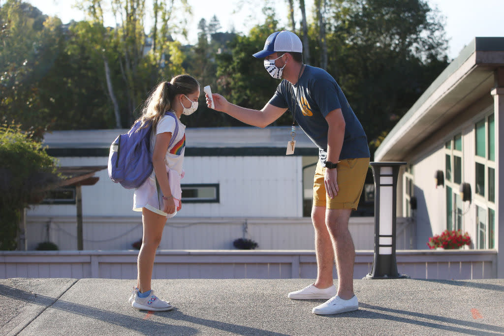 An elementary school student in Tiburon, Calif., gets her temperature taken on Oct. 16, 2020.