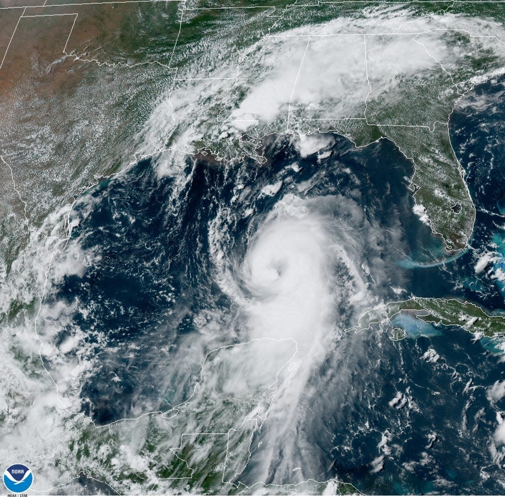 In this August 25, 2020 NOAA satellite photo, Hurricane Laura strengthens in the Gulf of Mexico while Marco drenches parts of the Southeast.