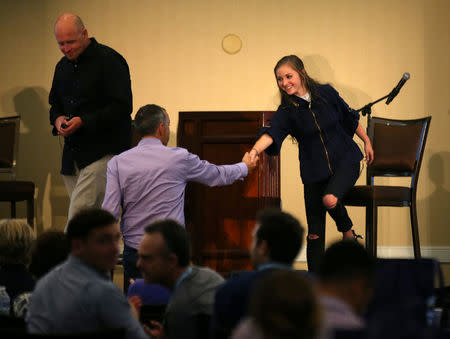 Millennial stock blogger Rachel Fox, 20, shakes hands with Howard Londzon, co-founder and chairman of Stocktwits, after she spoke to the group of investors, tech nerds and stock traders at StockTwits annual Stocktoberfest in Coronado, California, U.S. October 14, 2016. Picture taken October 14, 2016. REUTERS/Mike Blake