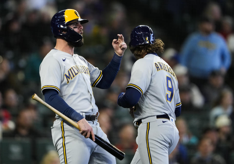 Milwaukee Brewers' Jesse Winker reacts after he and Brian Anderson (9) scored on a single by Brice Turang against the Seattle Mariners during the seventh inning of a baseball game Wednesday, April 19, 2023, in Seattle. (AP Photo/Lindsey Wasson)