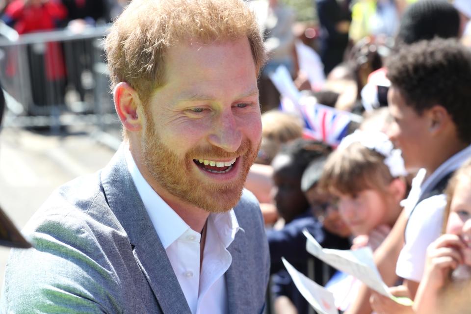 Prince Harry smiles at wellwishers as he arrives for a visit to the Barton Neighbourhood Centre on May 14, 2019 in Oxford, England.