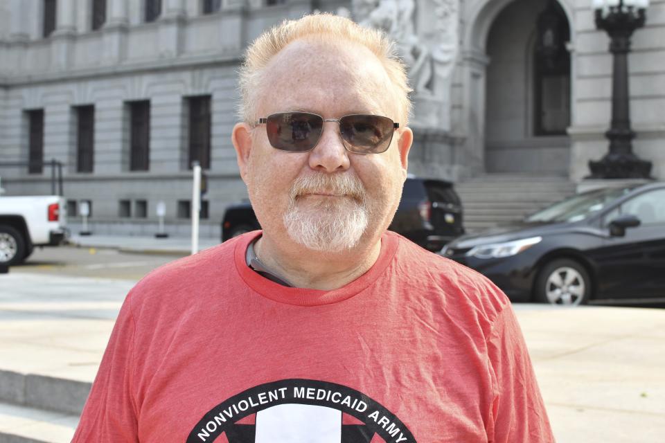Gary Rush poses for a photo outside the Pennsylvania Capitol, June 7, 2023, in Harrisburg, Pa. Rush was demonstrating with the advocacy group Power to the People against the state removing people from Medicaid and says he's worried about losing his medical coverage under the program. (AP Photo/Marc Levy)
