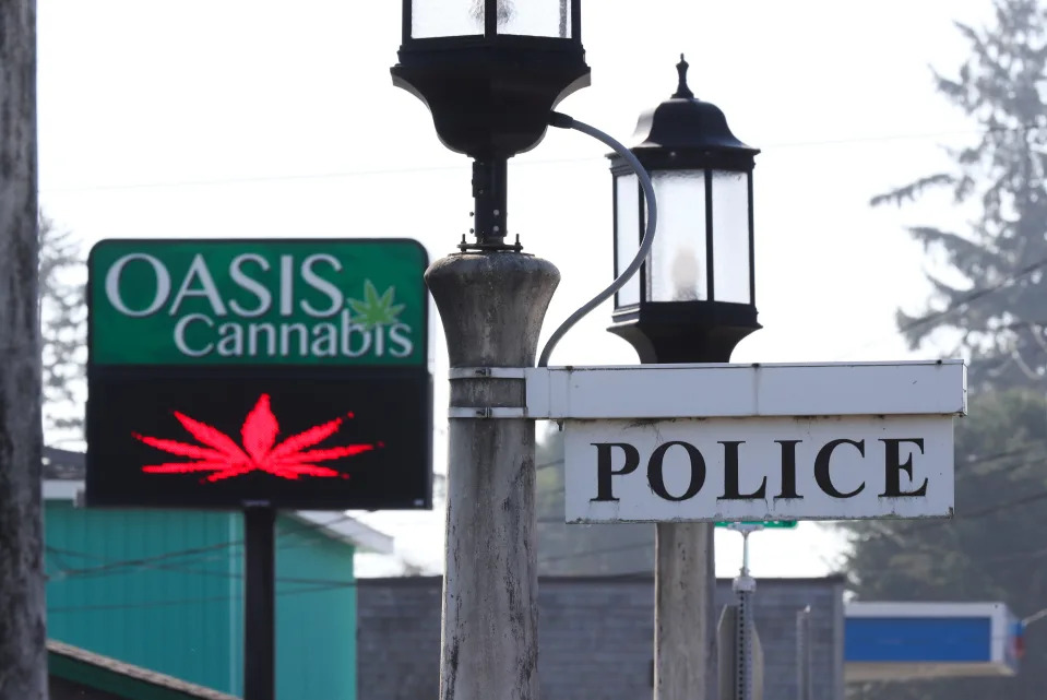 Oregon law allows a cannabis store to operate freely next door to the Seasaide Police Department in the coastal town of Seaside, Ore. on Oct. 13, 2022.  The town has been an unlikely place for Mexican cartels to distribute illegal drugs.  The cartels are able to operate under less scrutiny in areas such as this.