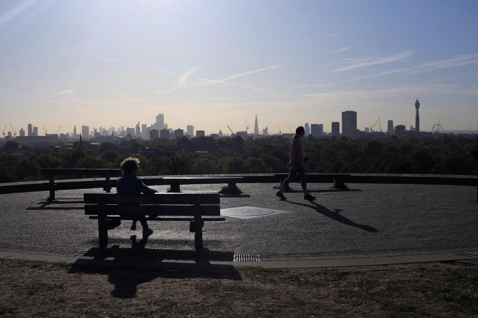 People walk to the top of Primrose Hill with the view of the London skyline, on Wednesday, Sept. 18, 2019. (AP Photo/Kiichiro Sato)