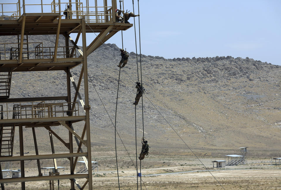 FILE - In this July 17, 2021 file photo, Afghan Army Special forces take part in a training exercise after a three-month training program at the Kabul Military Training Center in Kabul, Afghanistan. The US and NATO have promised to pay $4 billion a year until 2024 to finance Afghanistan’s military and security forces, which are struggling to contain an advancing Taliban. Already since 2001, the U.S. has spent nearly $89 billion to build, equip and train the forces. (AP Photo/Rahmat Gul, File)