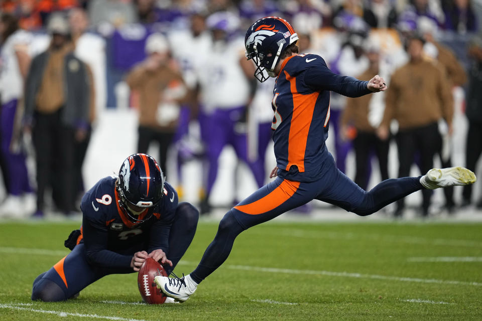 Denver Broncos place kicker Wil Lutz kicks a field goal as punter Riley Dixon (9) holds during the first half on an NFL football game against the Minnesota Vikings, Sunday, Nov. 19, 2023, in Denver. (AP Photo/Jack Dempsey)