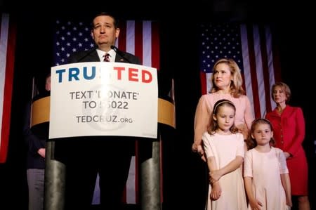 Republican presidential candidate Senator Ted Cruz, with his daughter Catherine (2nd L), wife Heidi (C), daughter Caroline (2nd R) and supporter and former rival Carly Fiorina (R) at his side, reacts to the primary election results in Florida, Ohio and Illinois during a campaign rally in Houston, Texas March 15, 2016. REUTERS/Trish Badger