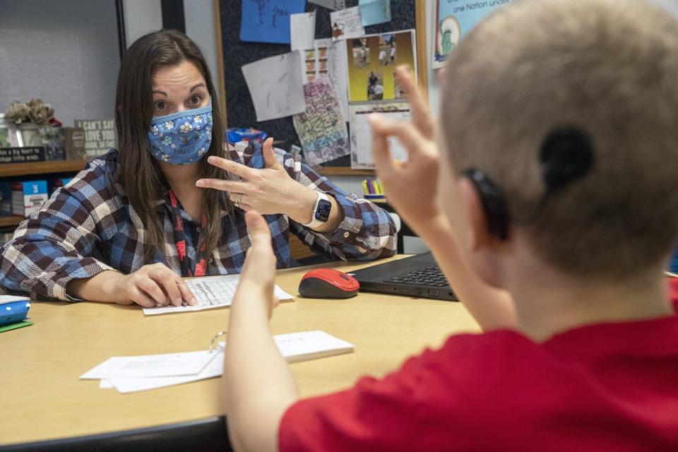 Megan Jones uses sign language in teaching a student at the Iowa School for the Deaf.
