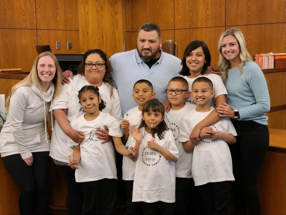 Ruby Celada and Armando Ayala along with their chidren and Erica Kirkman (to the left) and Heidi Roesder (to the right).