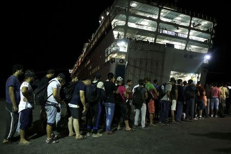 Syrian refugees prepare to board the passenger ship "Eleftherios Venizelos" at the port on the Greek island of Kos, August 15, 2015. REUTERS/Alkis Konstantinidis