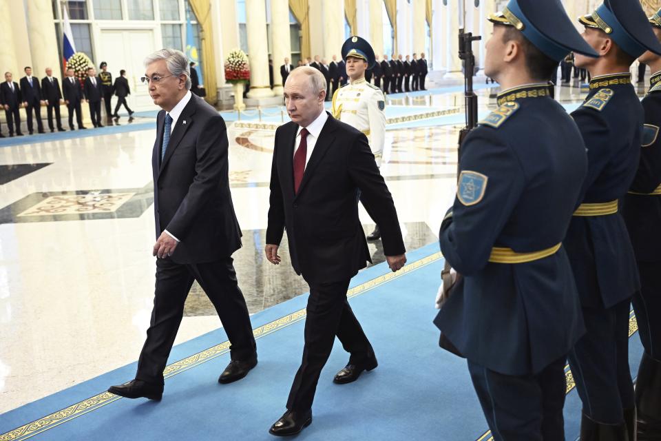 Kazakh President Kassym-Jomart Tokayev, left, and Russian President Vladimir Putin, center, attend an official welcome ceremony at the Akorda Presidential residence in Astana, Kazakhstan, Thursday, Nov. 9, 2023. (Pavel Bednyakov, Sputnik, Kremlin Pool Photo via AP)