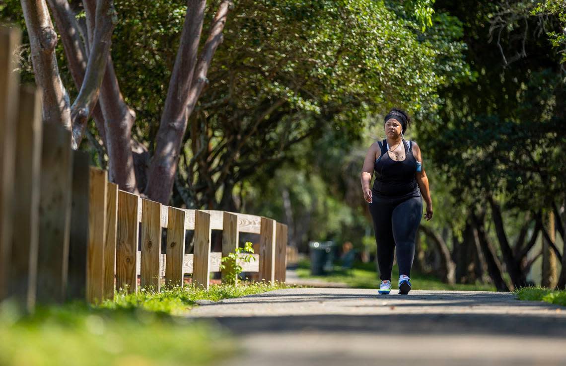 A woman visits Dolphins Linear Park on Wednesday, May 10, 2023, in Miami Gardens, Fla. Developers are preparing to construct a new destination district nearby, which will be named the Miami Gardens City Center.