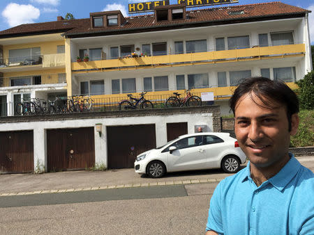 Pakistan migrant Mahmood Mubaritz talks to Reuters journalists outside this refugee shelter in Ansbach, Germany, July 25, 2016. REUTERS/Erik Kirschbaum