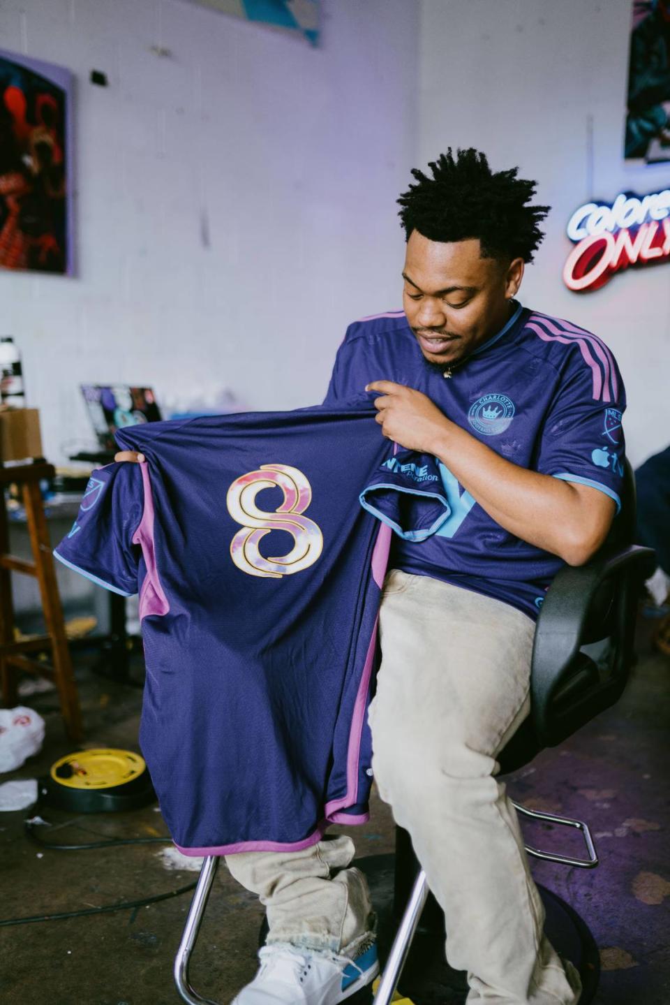 Behind the scenes of Mike Jones posing for Charlotte FC during a photoshoot for special edition Juneteenth jerseys.
