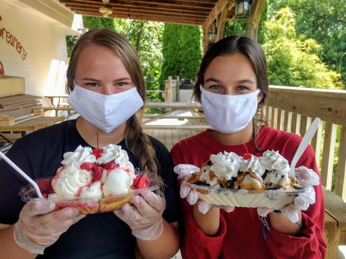 Workers Grace Flowers (left) with a Strawberry Cassata brownie sundae and Erin Steiner with a Trailbuster sundae at Cherry Street Creamery in Fulton Canal.