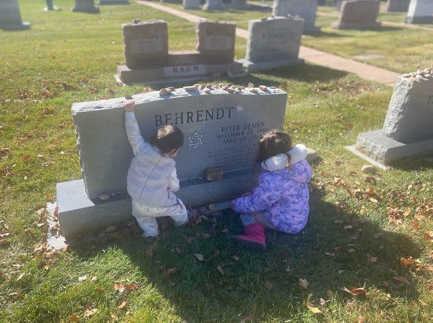 The author’s daughters visit his father’s gravesite.