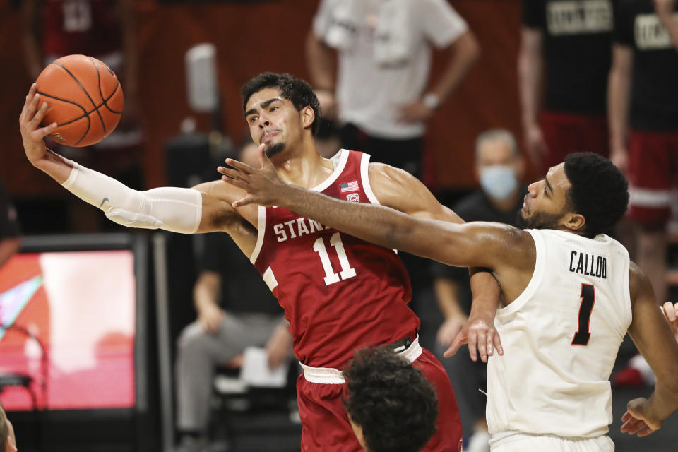 Stanford's Jaiden Delaire (11) and Oregon State's Maurice Calloo (1) fight for a rebound during the first half of an NCAA college basketball game in Corvallis, Ore., Monday, Jan. 4, 2021. (AP Photo/Amanda Loman)