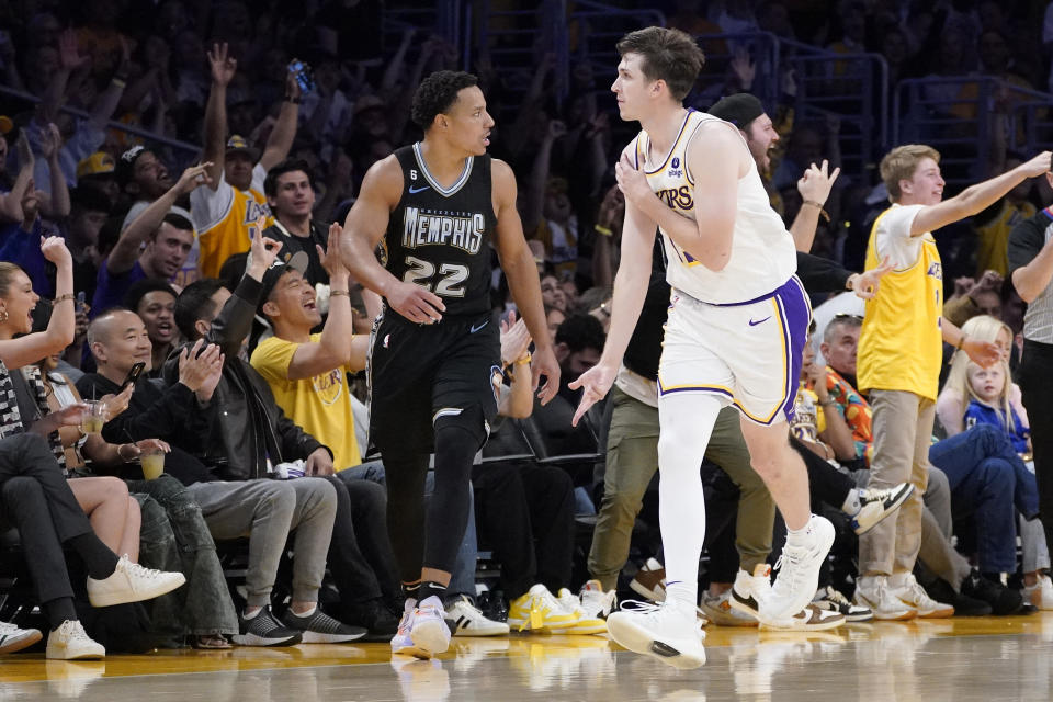 Los Angeles Lakers guard Austin Reaves, right, celebrates after scoring as Memphis Grizzlies guard Desmond Bane runs behind during the second half in Game 3 of a first-round NBA basketball playoff series Saturday, April 22, 2023, in Los Angeles. (AP Photo/Mark J. Terrill)