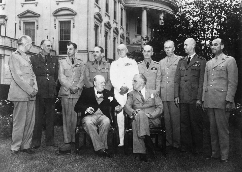 British Prime Minister Winston Churchill and US President Franklin D. Roosevelt pose on the lawn of the White House in Washington, DC, before a conference on the Allied war strategy, World War II, 7th June 1943. Behind them from left to right, are Field Marshal Sir John Dill, Lieutenant General Hastings Ismay, Air Chief Marshal Sir Charles Portal, General Sir Alan Brooke, Admiral of the Fleet Sir Dudley Pound, Admiral William D. Leahy, the US Naval Chief of Staff, General George C. Marshall, US Chief of Staff, Admiral Ernest J. King, Chief of Naval Operations, and Lieutenant General Joseph T. McNarney of the US Army General Staff.