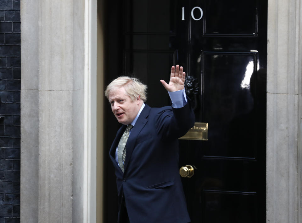 Britain's Prime Minister Boris Johnson waves as he arrives back at 10 Downing Street in London, Friday, Dec. 13, 2019 after meeting Queen Elizabeth II to seek her approval to form a new government. Prime Minister Boris Johnson's Conservative Party has won a solid majority of seats in Britain's Parliament — a decisive outcome to a Brexit-dominated election that should allow Johnson to fulfill his plan to take the U.K. out of the European Union next month. (AP Photo/Frank Augstein)