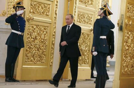 Russia's President Vladimir Putin walks past honor guards as he attends a ceremony to receive diplomatic credentials from foreign ambassadors at the Kremlin in Moscow, Russia, November 26, 2015. REUTERS/Sergei Ilnitsky/Pool