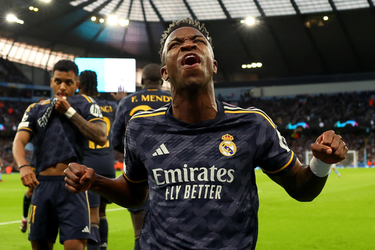 MANCHESTER, ENGLAND - APRIL 17: Vinicius Junior of Real Madrid celebrates after teammate Rodrygo (not pictured) scored his team's first goal during the UEFA Champions League quarter-final second leg match between Manchester City and Real Madrid CF at Etihad Stadium on April 17, 2024 in Manchester, England.(Photo by Marc Atkins/Getty Images)