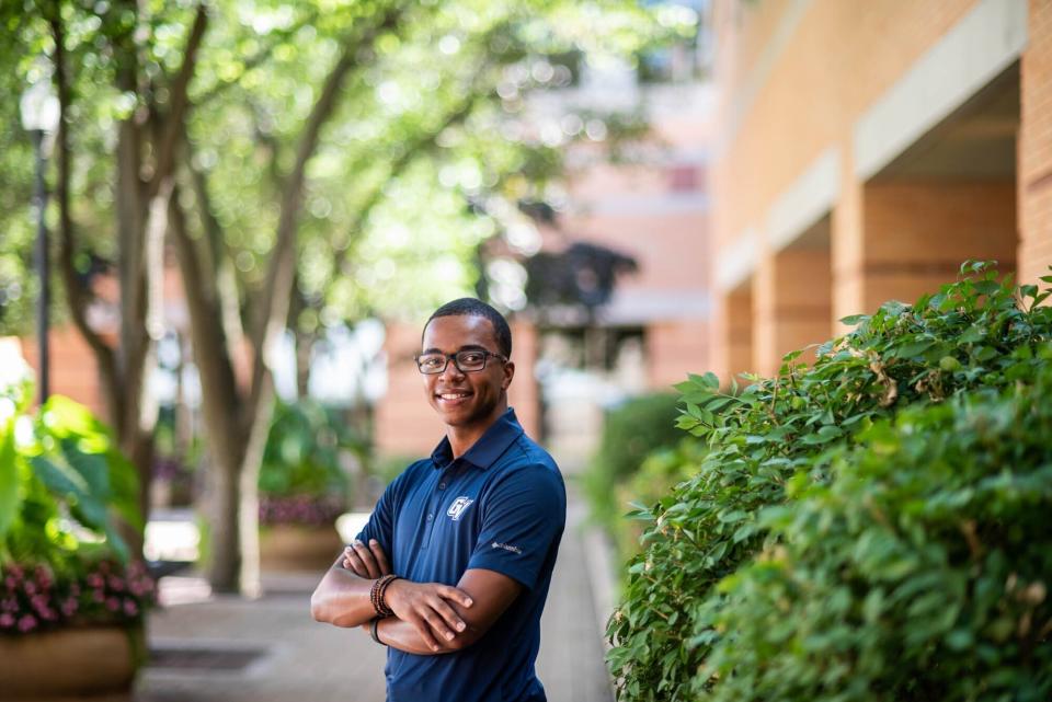 In this photo provided by Grand Valley State University, student Julian Sanders a political science major from Flint, Mich., stands for a portrait on Wednesday, May 12, 2021 in Allendale, Mich. Sanders, who was a mentor in last summer's Learner Engagement Challenge, said the solutions the students came up with would have filled a gap in his own college experience. While high school taught him how to succeed in a classroom, he said he struggled with other aspects of the college transition. (Kendra Stanley-Mills/Grand Valley State University via AP)