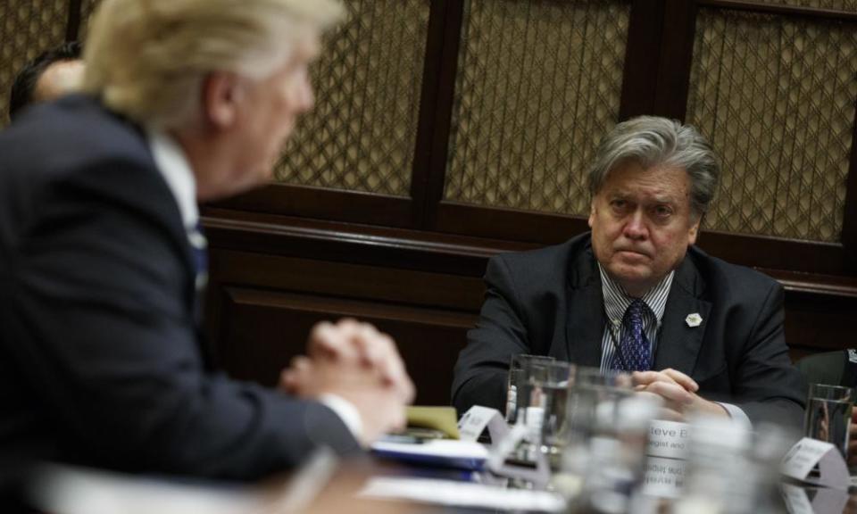 Steve Bannon listens as Donald Trump speaks during a meeting shortly after he took office.