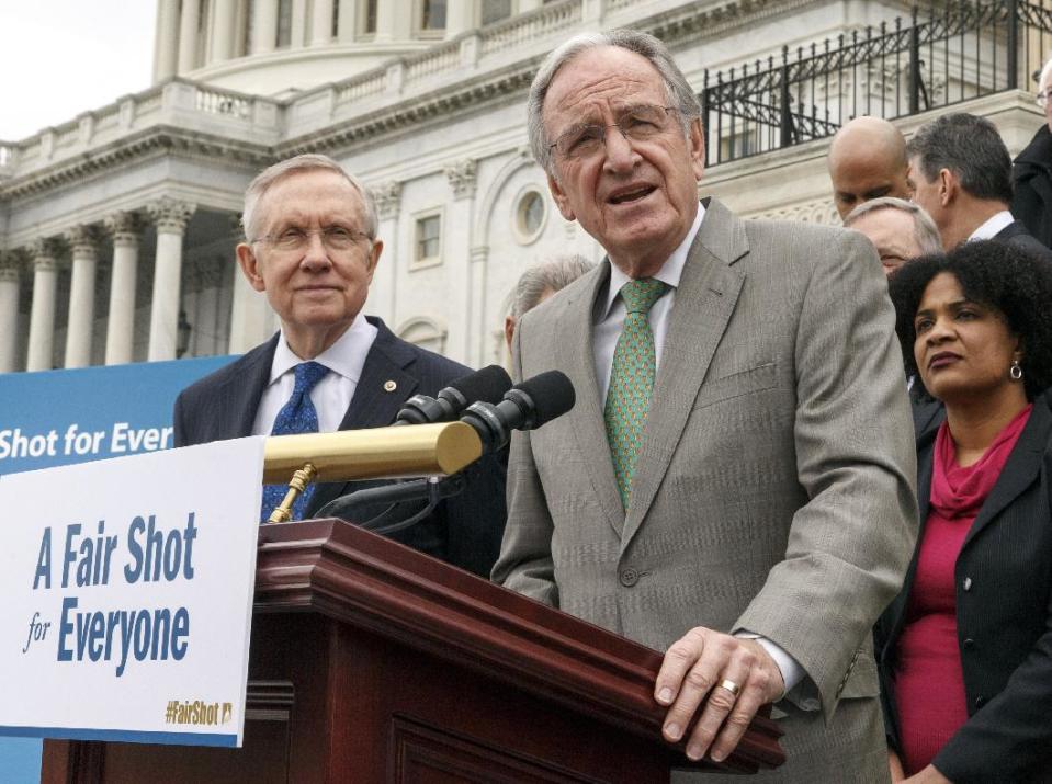 FILE - This April 2, 2014 file photo shows Senate Health, Education, Labor and Pensions Committee Chairman Sen. Tom Harkin, D-Iowa, right, accompanied by Senate Majority Leader Harry Reid of Nev., left, and others, urging approval for raising the minimum wage, during a news conference on Capitol Hill in Washington. When the Senate debates a Democratic proposal to raise the federal minimum wage, some workers won’t benefit even if lightning strikes and the long-shot effort prevails. More than a dozen categories of workers are exempt from the current $7.25-an-hour minimum, running from casual babysitters to some workers with disabilities to crews on fishing ships. The bill by Harkin, would gradually raise the minimum to $10.10 by 2016 but doesn’t close any loopholes, which also include live-in companions for the elderly, staffs of state and local elected officials and jobs at summer camps and seasonal amusement parks. (AP Photo/J. Scott Applewhite, File)