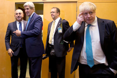 U.S. Secretary of State John Kerry greets Turkish Foreign Minister Mevlut Cavusoglu (L) next to Britain's Foreign Secretary Boris Johnson (R) during a NATO foreign ministers meeting at the Alliance headquarters in Brussels, Belgium, December 6, 2016. REUTERS/Virginia Mayo/Pool