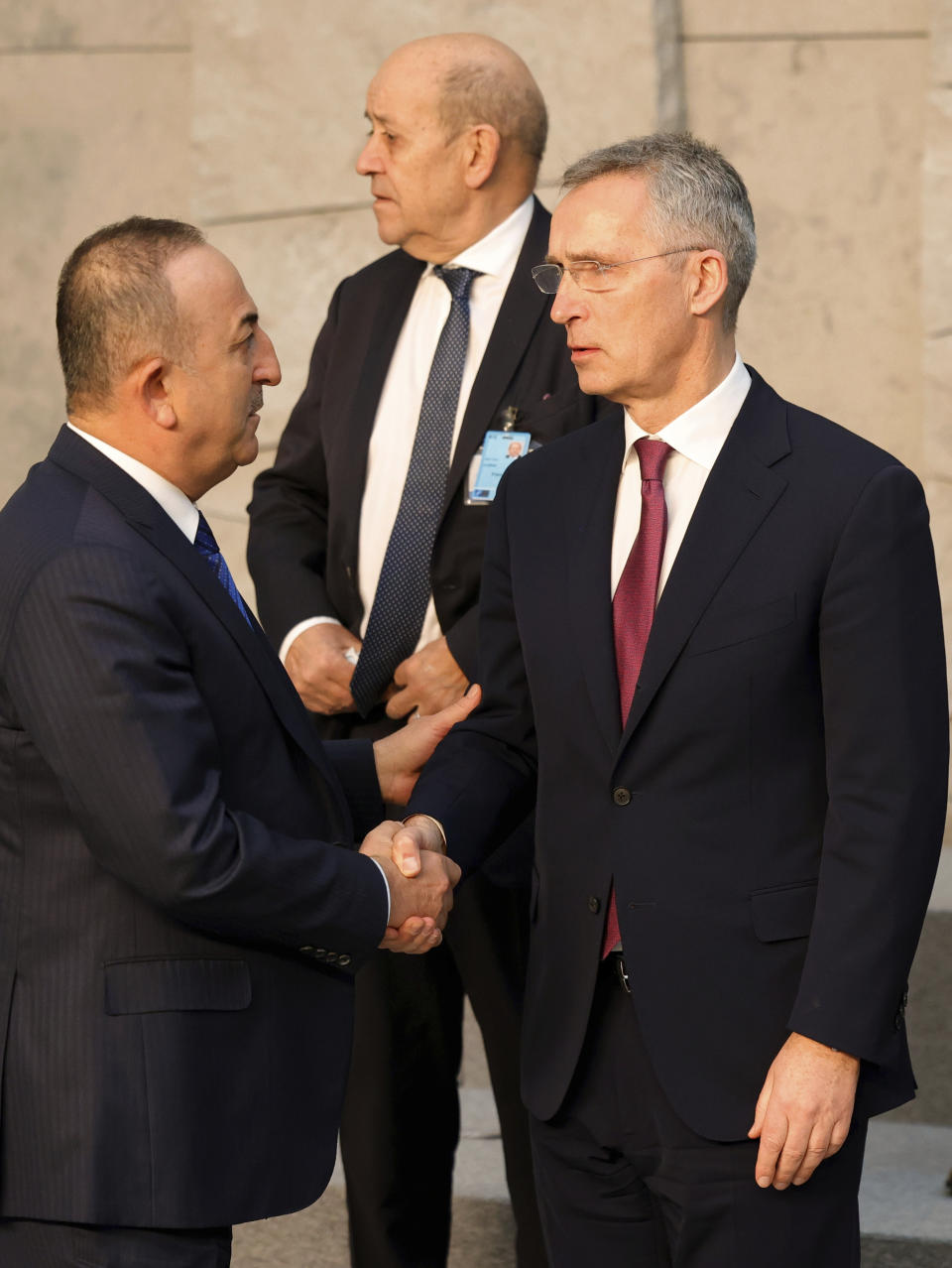 Turkish Foreign Minister Mevlut Cavusoglu, left, speaks with NATO Secretary General Jens Stoltenberg during a group photo at an extraordinary NATO foreign ministers meeting at NATO headquarters in Brussels, Friday, March 4, 2022. U.S. Secretary of State Antony Blinken meets Friday with his counterparts from NATO and the European Union, as Russia's war on Ukraine entered its ninth day marked by the seizure of the strategic port city of Kherson and the shelling of Europe's largest nuclear power plant. (AP Photo/Olivier Matthys)