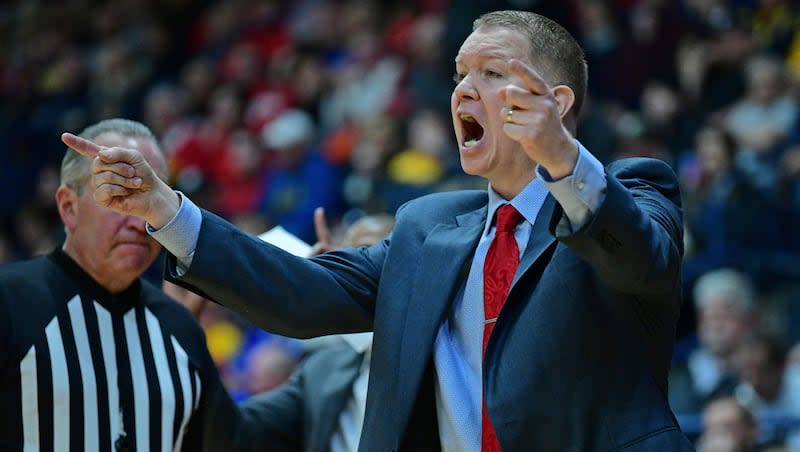 Youngstown State head coach Jerrod Calhoun shouts instructions from the bench during the first half of an NCAA college basketball game against West Virginia, Saturday, Dec. 21, 2019, in Youngstown, Ohio. West Virginia won 75-64.