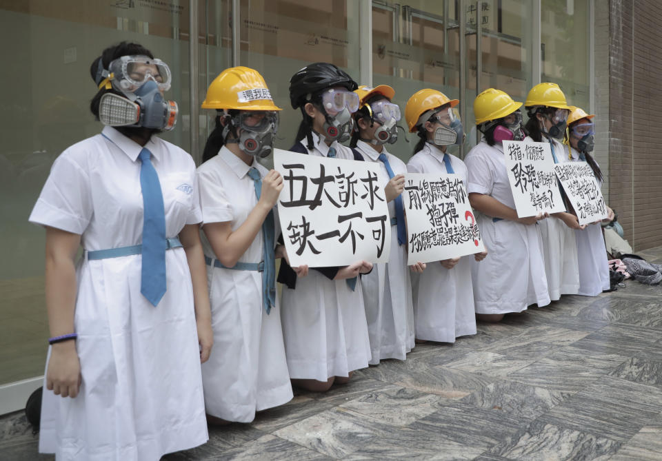 Students wearing gas masks and helmets hold a banner which reads "Five major demands are indispensable.", at St. Francis' Canossian College in Hong Kong, on Monday, Sept. 2, 2019. Hong Kong has been the scene of tense anti-government protests for nearly three months. The demonstrations began in response to a proposed extradition law and have expanded to include other grievances and demands for democracy in the semiautonomous Chinese territory. (AP Photo)