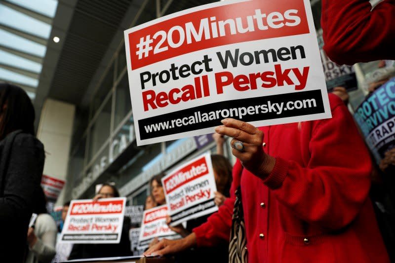 Activists hold signs calling for the removal of Judge Aaron Persky from the bench after his controversial sentencing in the Stanford rape case, in San Francisco, California, U.S. June 10, 2016.  REUTERS/Stephen Lam