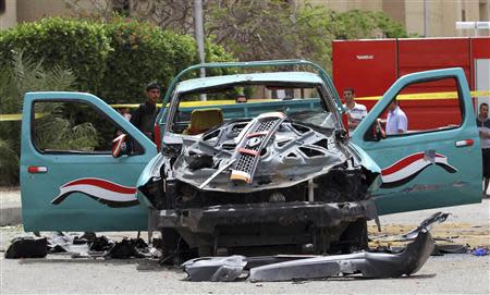 A damaged car of Brigadier General Ahmed Zaki, who was killed in an explosion outside his home, is pictured in 6th of October City, 32 km (20 miles) outside Cairo April 23, 2014. REUTERS/Al Youm Al Saabi Newspaper