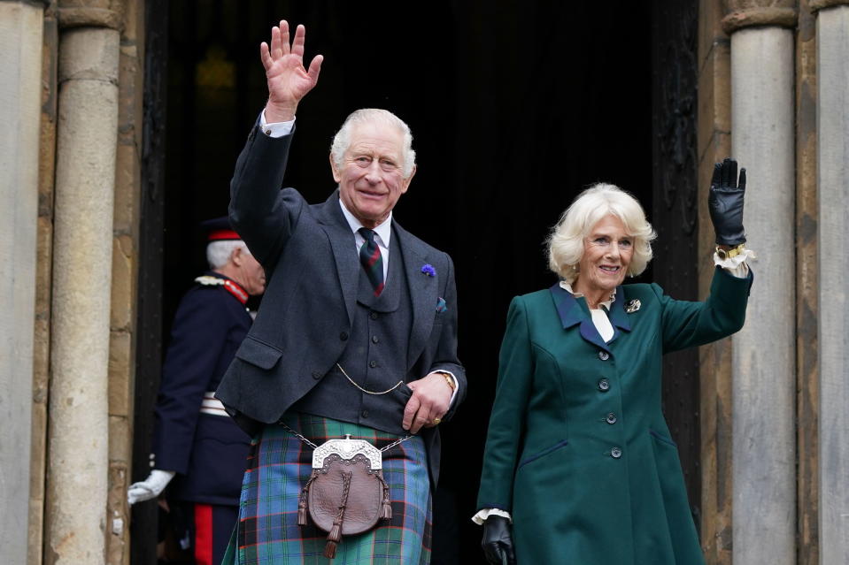 Britain's King Charles III and Camilla, the Queen Consort, wave as they leave Dunfermline Abbey, after a visit to mark its 950th anniversary, and after attending a meeting at the City Chambers in Dunfermline, Fife, where the King formally marked the conferral of city status on the former town. (Andrew Milligan/PA via AP)