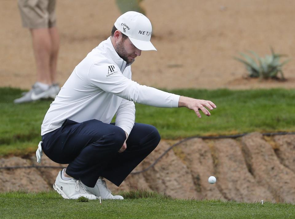 Branden Grace takes a drop after his tee shot went into the water on the 17th hole during the final round of the Waste Management Phoenix Open at the TPC Scottsdale Feb. 3, 2019.