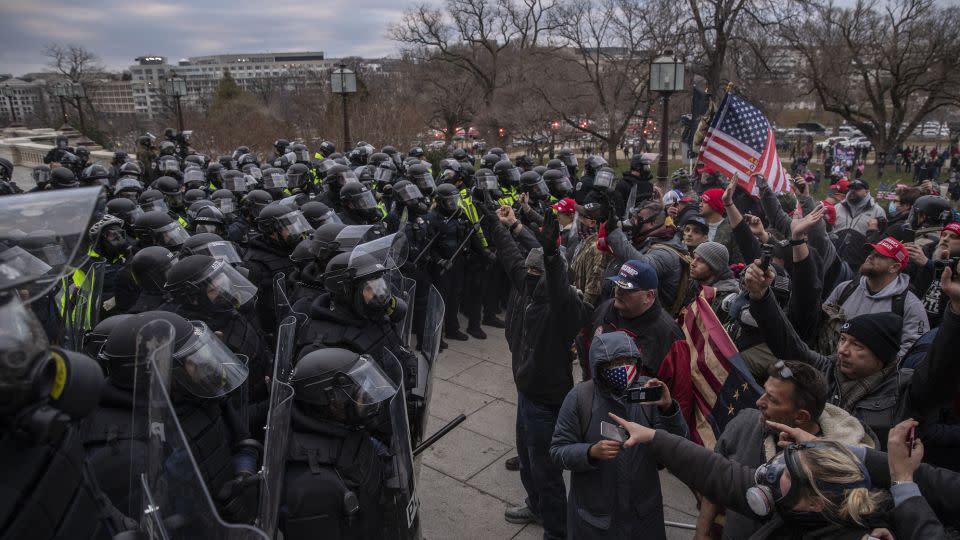 Police attempt to clear protesters trying to breach the US Capitol in Washington on January 6, 2021. The authors of a new book say some of the gravest threats to American democracy have occurred since that insurrection. - Victor J. Blue/Bloomberg/Getty Images