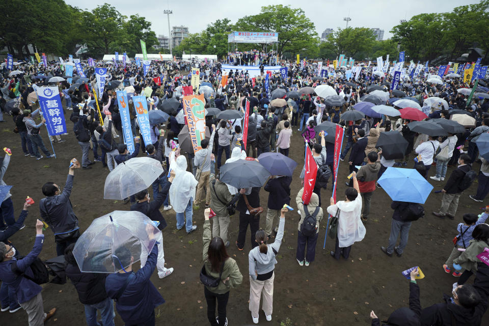 FILE - Trade unions members participate in a May Day assembly in the rain on April 29, 2022, in Tokyo. Wages are rising in Japan more than they have in decades, at least for some workers. But so are prices, leaving many people feeling they must scrimp more than ever.(AP Photo/Eugene Hoshiko, File)