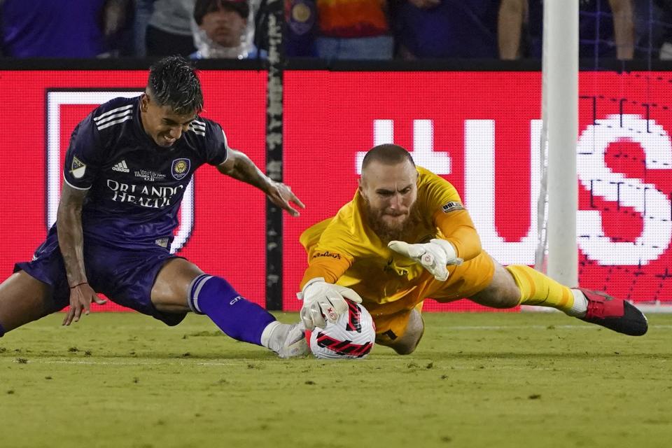 Orlando City's Facundo Torres, left, tries to get position as Sacramento Republic goalkeeper Danny Vitiello dives for the ball during the second half of the U.S. Open Cup final soccer match Wednesday, Sept. 7, 2022, in Orlando, Fla. (AP Photo/John Raoux)