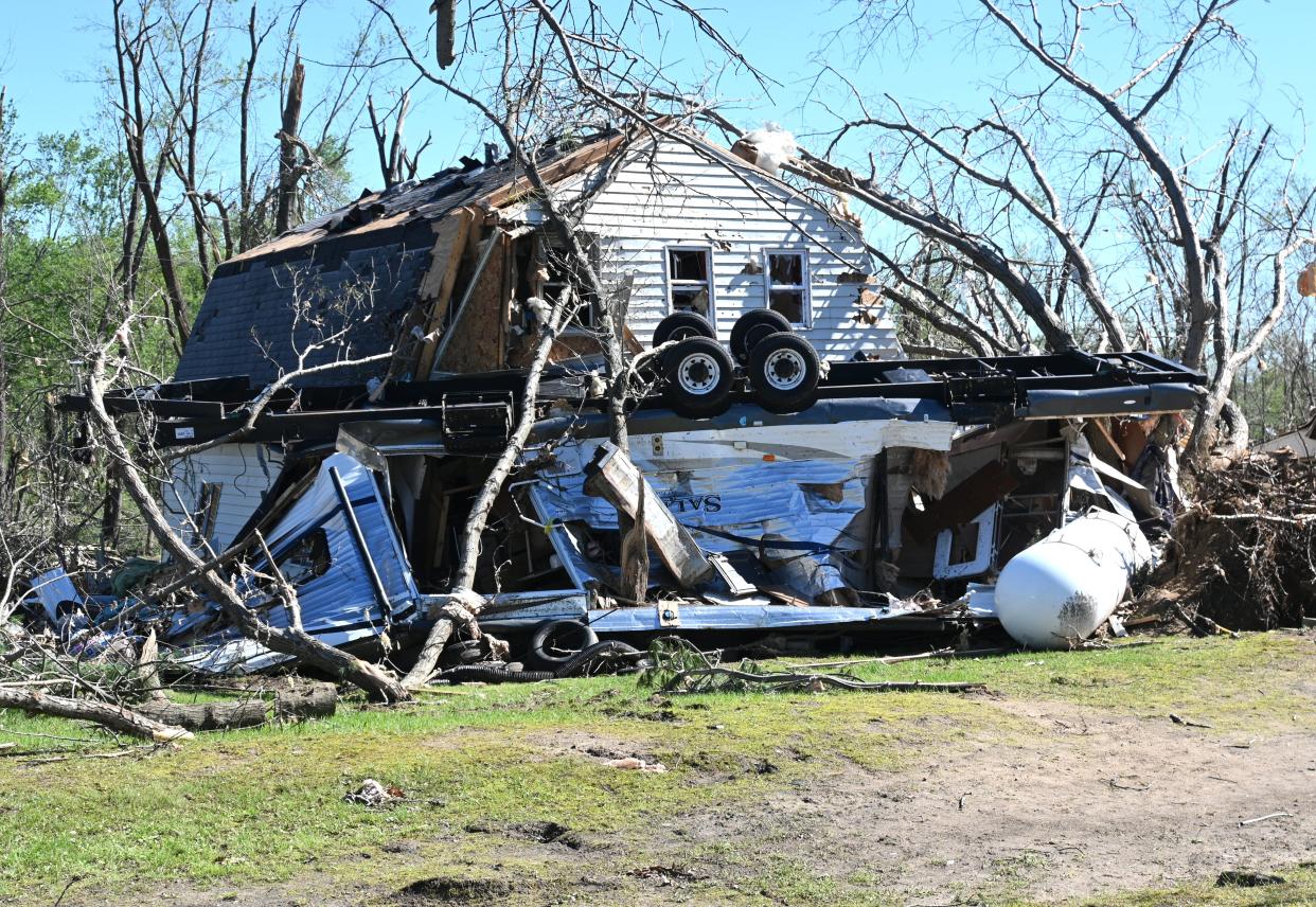 The tornado smashed a travel trailer into the home next door to Lynn Burns.