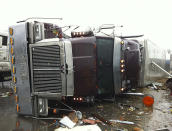 In this image made from video and released by WSB TV in Atlanta, a tractor and trailer rest on the highway after a tornado moved through the town of Adairsville, Ga. on Wednesday, Jan 30, 2013. A fire chief says a storm that roared across northwest Georgia has left overturned vehicles on Interstate 75 northwest of Atlanta, and crews are responding to reports of people trapped in storm-damaged residential and commercial buildings. (AP Photo/WSB TV)