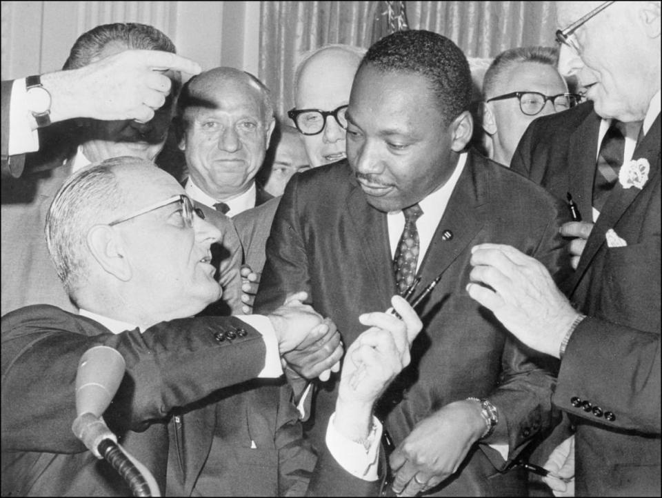 <div class="inline-image__caption"><p>President Lyndon Johnson shakes hands with Dr. Martin Luther King Jr. on July 3, 1964, in Washington D.C., after handing him a pen during the ceremonies for the signing of the civil rights bill at the White House.</p></div> <div class="inline-image__credit">AFP via Getty</div>