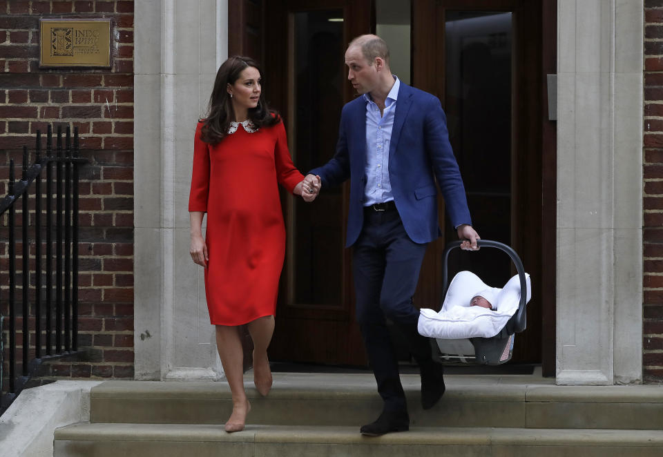 FILE - In this April 23, 2018 file photo, Britain's Prince William and Kate, Duchess of Cambridge with their newborn baby son, leave the Lindo wing at St. Mary's Hospital in London London. With another royal baby on the horizon, the debate over postpartum perfection is alive and well. As it stands, we don’t know whether Meghan Markle will follow in the footsteps of Kate Middleton when it comes to that magical perfection, but we have an inkling she’ll at least slap on some makeup when she introduces the latest royal to the world next month. (AP Photo/Kirsty Wigglesworth, File)