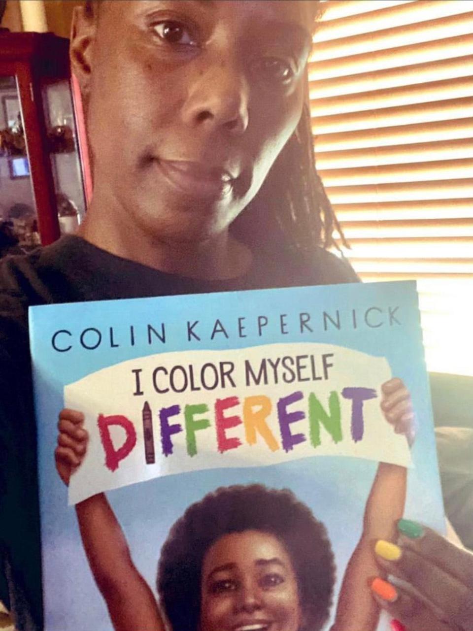 Dannette Justus read the book “I Color Myself Different” by former NFL star Colin Kaepernick in front of a beautiful book mural on Vliet Street in Milwaukee.