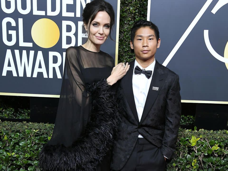 Angelina Jolie has been busy taking her kids to public events, seen here with Pax earlier this month at the Golden Globes. Source: Getty